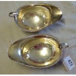 Two silver sauce boats- by Selfridges Ltd-numbered 75840, hallmarked London 1914, tripod feet,