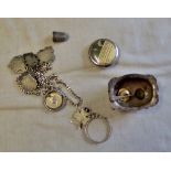 A mix collection of silver and white objects, including a silver mustard pot with spoon and