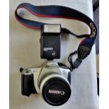 Canon E63-300 camera with flash bulb and strap for carrying round neck