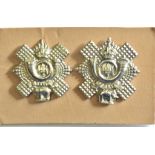 British WWII Highland Light Infantry collar badge pair, left and right facing designs. White metal