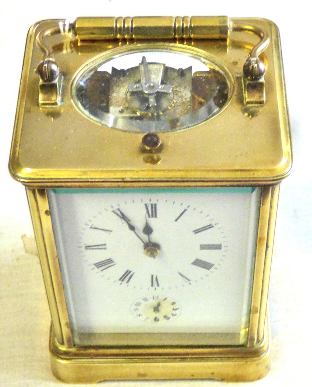 Clock Brass cased carriage clock, unusual movement chiming, in working order, damage to the door and