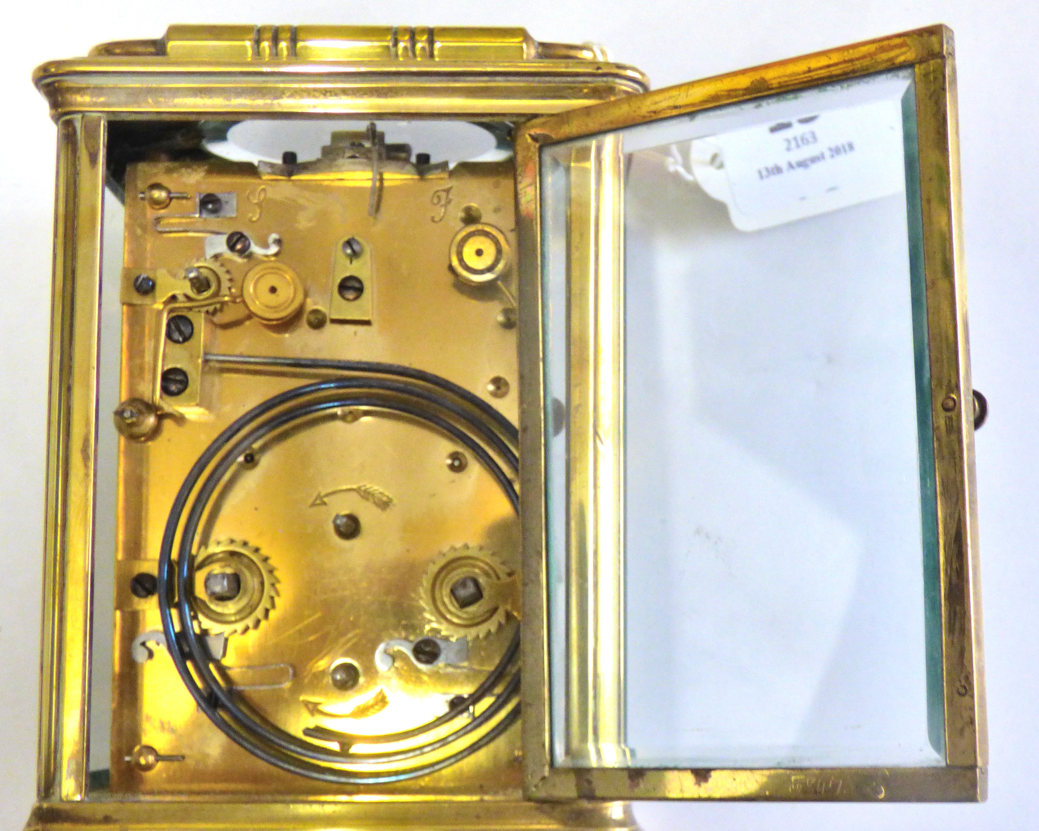 Clock Brass cased carriage clock, unusual movement chiming, in working order, damage to the door and - Image 3 of 5