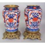 A PAIR OF GILT METAL MOUNTED JAPANESE MEIJI PERIOD IMARI PORCELAIN VASES, each painted in typical