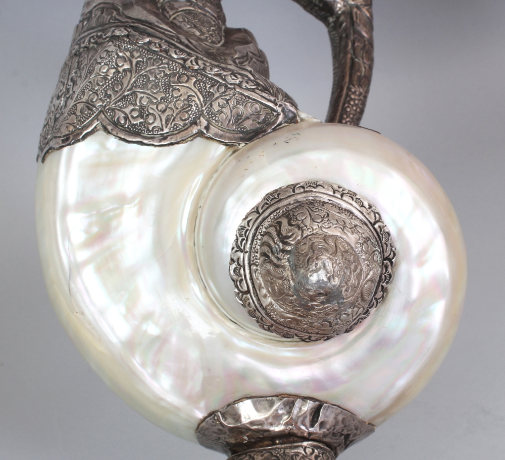 AN UNUSUAL PAIR OF TIBETAN SILVER-METAL MOUNTED NAUTILUS SHELLS, each shell with elaborately - Image 6 of 8