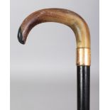 A RHINO HORN HANDLED WOOD WALKING STICK, with a gilt-metal collar engraved with a monogram, the