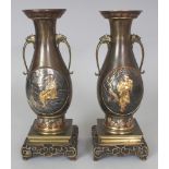 A GOOD PAIR OF JAPANESE MEIJI PERIOD MIXED METAL VASES, each supported on a fixed square-section