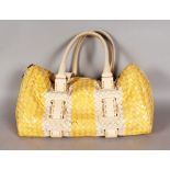 A BOTTEGA VENETA YELLOW AND CREAM WOVEN LEATHER HANDBAG.