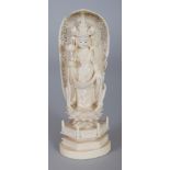 A SIGNED JAPANESE MEIJI PERIOD IVORY OKIMONO OF KWANNON, standing on a lotus plinth and bearing a