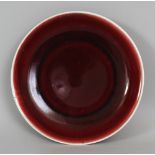 A CHINESE COPPER RED PORCELAIN DISH, the base with a six-character Xuande mark, 9.2in diameter.