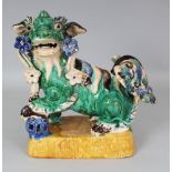 A 20TH CENTURY CHINESE SHIWAN GLAZED CERAMIC MODEL OF A BUDDHISTIC LION, 10in long & also 10in