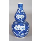 A 19TH CENTURY CHINESE BLUE & WHITE DOUBLE GOURD PORCELAIN PRUNUS VASE, the base with a four-