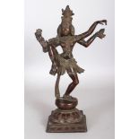 A 19TH CENTURY INDIAN BRONZE FIGURE OF SHIVA, in a posture of dance on a square-section lotus