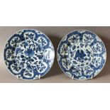 A PAIR OF CHINESE KANGXI PERIOD BLUE & WHITE SHIPWRECK PORCELAIN PLATES, circa 1700, each base