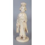 A SIGNED JAPANESE MEIJI PERIOD IVORY OKIMONO OF A STANDING BIJIN, holding a fan by her side, the