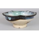 AN UNUSUAL JAPANESE GLAZED CERAMIC BOWL, 7.3in diameter & 3in high.