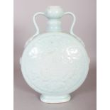 A CHINESE CELADON MOULDED PORCELAIN MOON FLASK, the base with a Qianlong seal mark, 8.7in wide at