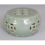 AN UNUSUAL CHINESE CELADON GLAZED MODEL OF A GARDEN SEAT, the base with a Qianlong seal mark, 4.25in
