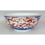 A LARGE CHINESE MING STYLE IRON-RED & UNDERGLAZE-BLUE PORCELAIN DRAGON BOWL, the base with a six-