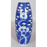 A 19TH CENTURY BLUE & WHITE OVAL FORM PORCELAIN PRUNUS VASE, the base with a four-character Kangxi