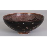 A CHINESE SONG STYLE PAPERCUT DECORATED CERAMIC BOWL, the base unglazed, 6.3in diameter & 2.6in