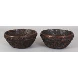 A PAIR OF CHINESE BUDDHIST EMBLEM & DRAGON MOULDED BOWLS, 5.9in diameter & 2.6in high.