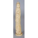 A 19TH CENTURY CHINESE IVORY CARVING OF A STANDING LADY, holding a bird and a jade-form pendant, the