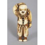 A GOOD QUALITY JAPANESE EDO/MEIJI PERIOD IVORY NETSUKE OF A STANDING BOY, the buttons of his costume