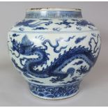 A LARGE CHINESE MING STYLE BLUE & WHITE PORCELAIN DRAGON JAR, the base unglazed, 14.25in wide at