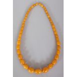 AN AMBER-STYLE BUTTERSCOTCH NECKLACE, weighing approx. 81.1gm, composed of graduated oval beads,