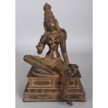 A 19TH INDIAN BRONZE FIGURE OF PARVATI, seated in lalitasana on a rectangular plinth, 6.8in x 4.25in