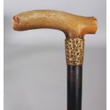 HORN HANDLED WOOD WALKING STICK, with a gilt-metal collar bearing a shield and scroll work and