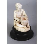 A GOOD QUALITY 19TH/20TH CENTURY BURMESE IVORY FIGURE OF A BASKET MAKER, 4.4in high overall, the