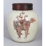 A CHINESE COPPER RED PORCELAIN KYLIN JAR, together with a fitted pierced wood cover, the base with a