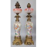 A GOOD LARGE PAIR OF 19TH CENTURY ORMOLU MOUNTED CANTON PORCELAIN OIL LAMPS, approx. 26.75in high