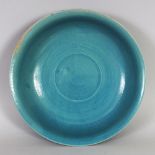 A CHINESE TURQUOISE GLAZED PORCELAIN BOWL, with an everted rim, the base moulded with a two-