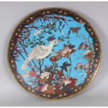 A JAPANESE MEIJI PERIOD CLOISONNE DISH, decorated with a bird perched on foliage, 14.3in diameter.
