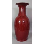 A LARGE 19TH CENTURY CHINESE SANG-DE-BOEUF GLAZED PORCELAIN VASE, the unglazed base fired brown,