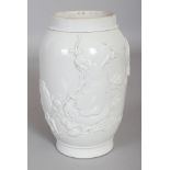 A CHINESE WHITE GLAZED WANG BINRONG TYPE MOULDED PORCELAIN JAR, the sides decorated in relief with