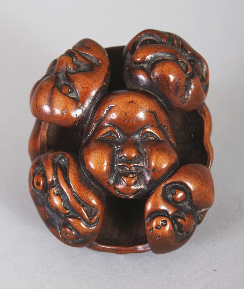 A GOOD QUALITY JAPANESE MEIJI PERIOD WOOD NOH MASK NETSUKE, carved and pierced with nine