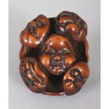A GOOD QUALITY JAPANESE MEIJI PERIOD WOOD NOH MASK NETSUKE, carved and pierced with nine