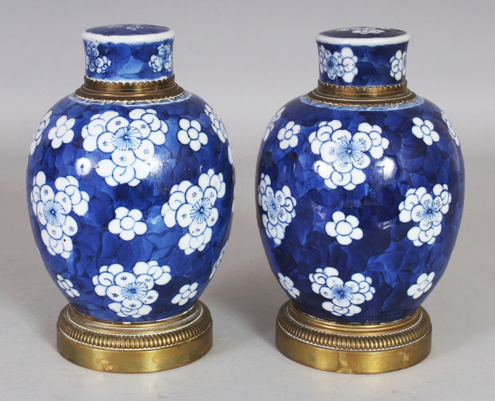 A GOOD PAIR OF CHINESE KANGXI PERIOD GILT-METAL MOUNTED BLUE & WHITE PORCELAIN JARS & COVERS, the