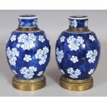 A GOOD PAIR OF CHINESE KANGXI PERIOD GILT-METAL MOUNTED BLUE & WHITE PORCELAIN JARS & COVERS, the