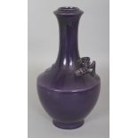 A CHINESE AUBERGINE GLAZED PORCELAIN VASE, the shoulders moulded in relief with a chilong, 9in