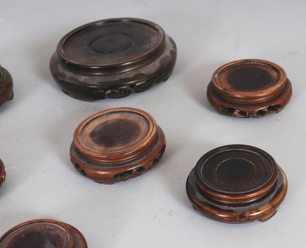 A SMALL COLLECTION OF NINE JAPANESE WOOD VASE STANDS, the largest 3.5in diameter. (9) - Image 2 of 3