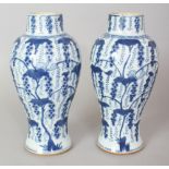 A PAIR OF CHINESE KANGXI PERIOD BLUE & WHITE PORCELAIN VASES, circa 1700, 9.25in high.