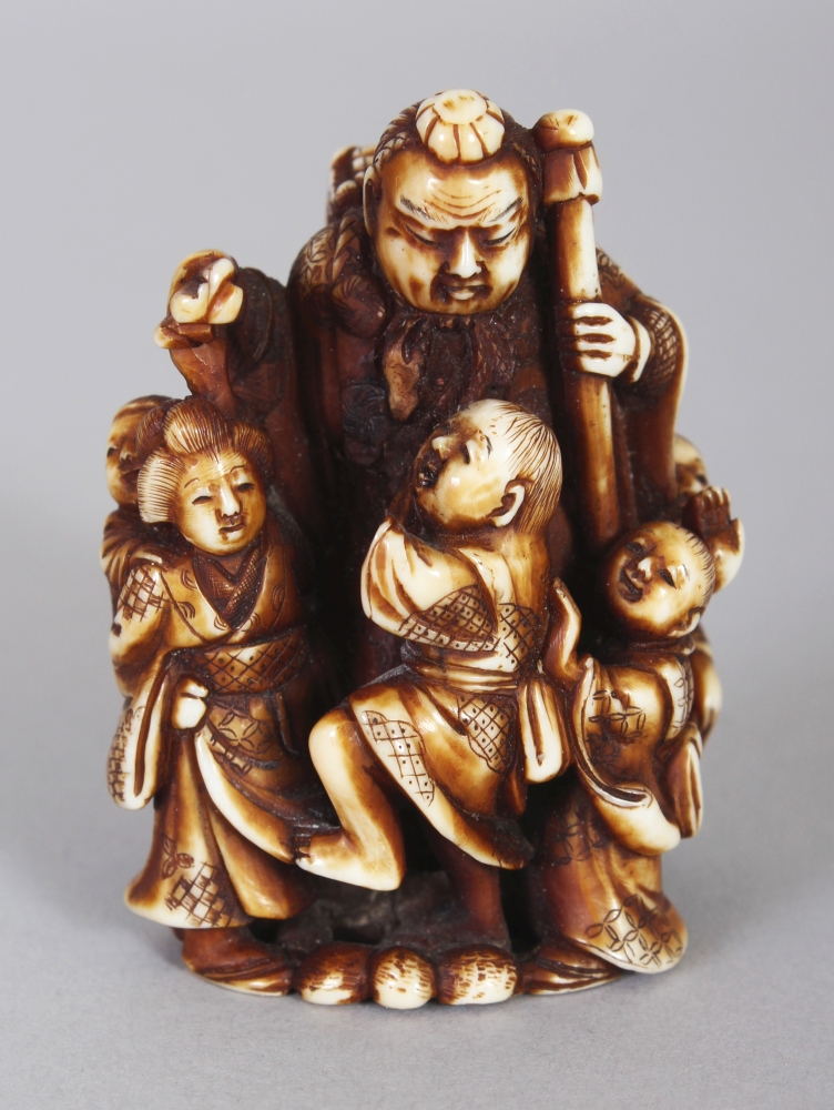 A GOOD QUALITY SIGNED JAPANESE MEIJI PERIOD STAINED IVORY NETSUKE, carved in the form of a