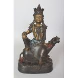 A SINO-TIBETAN GILT BRONZE FIGURE OF GUANYIN, seated on the back of a mythical animal, the base with