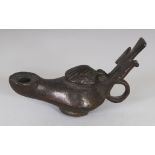 AN EARLY BYZANTINE BRONZE OIL LAMP, with shell cover and cross ornamented handle, 5.3in long overall