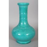 A CHINESE TURQUOISE GLAZED PORCELAIN BOTTLE VASE, with a ribbed neck, the base with a six-