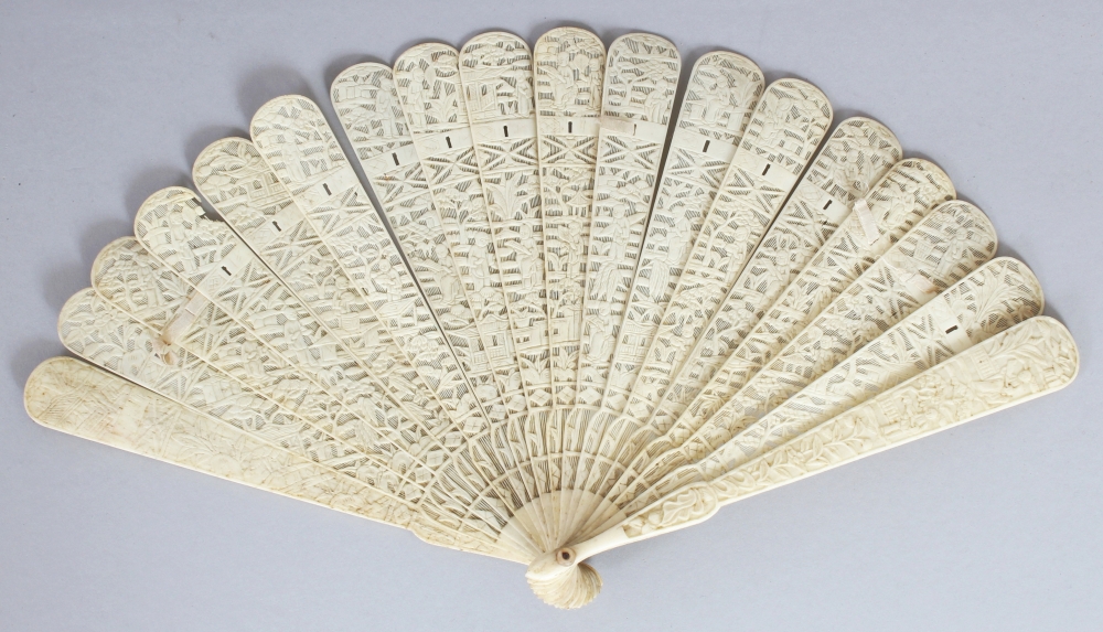 A 19TH CENTURY CHINESE CANTON IVORY FAN, with sixteen pierced and carved inner sticks, the guard